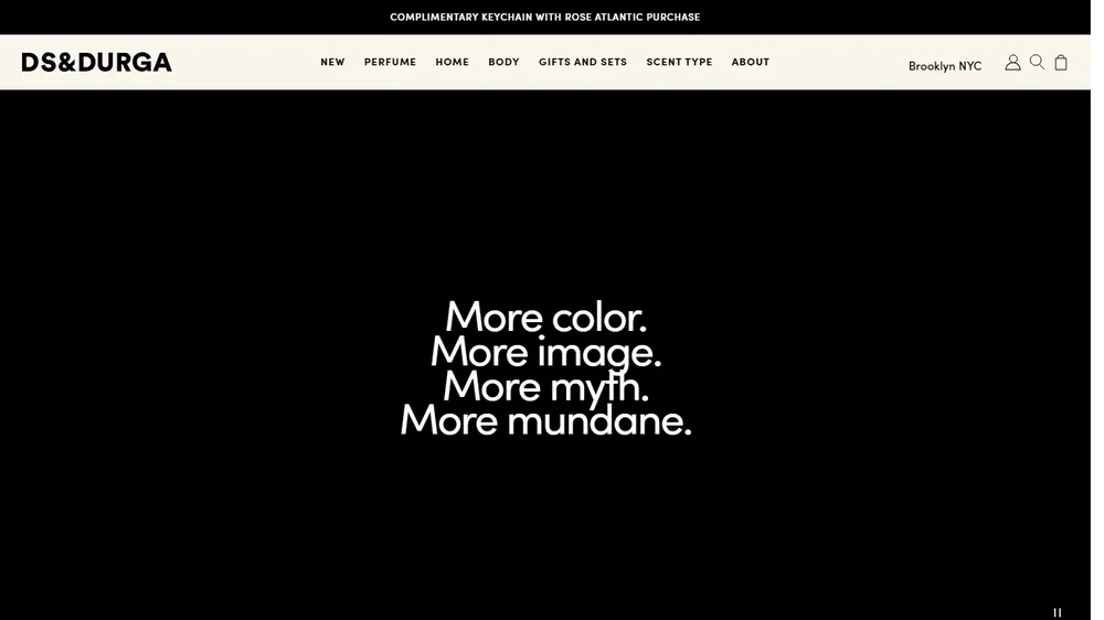 The D.S. & DURGA homepage: the wordmark and perfume nav above a dim video of stacked perfume boxes and bottles.