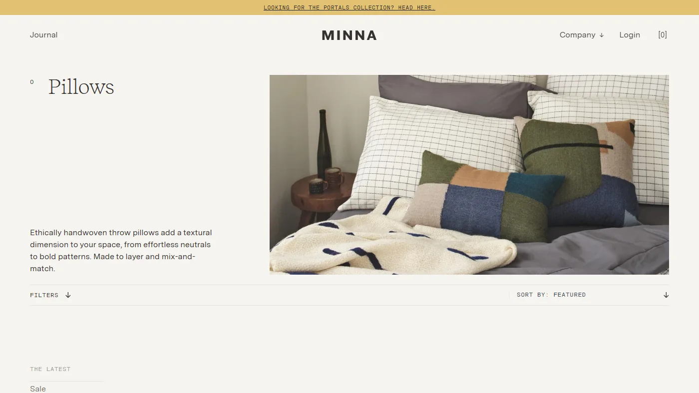 The MINNA wordmark above the Pillows collection page: colour-blocked cushions and a cream throw on grid-check bedding.