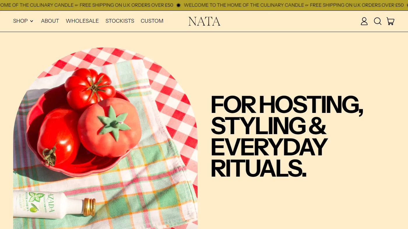 The Nata homepage: a centred serif wordmark and shop menu above an arched photo of tomato candles in a red scalloped bowl.